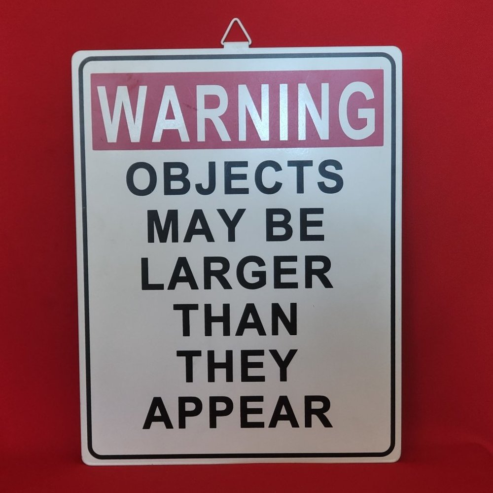Metal Sign Warning Objects May Be Larger Than They Appear